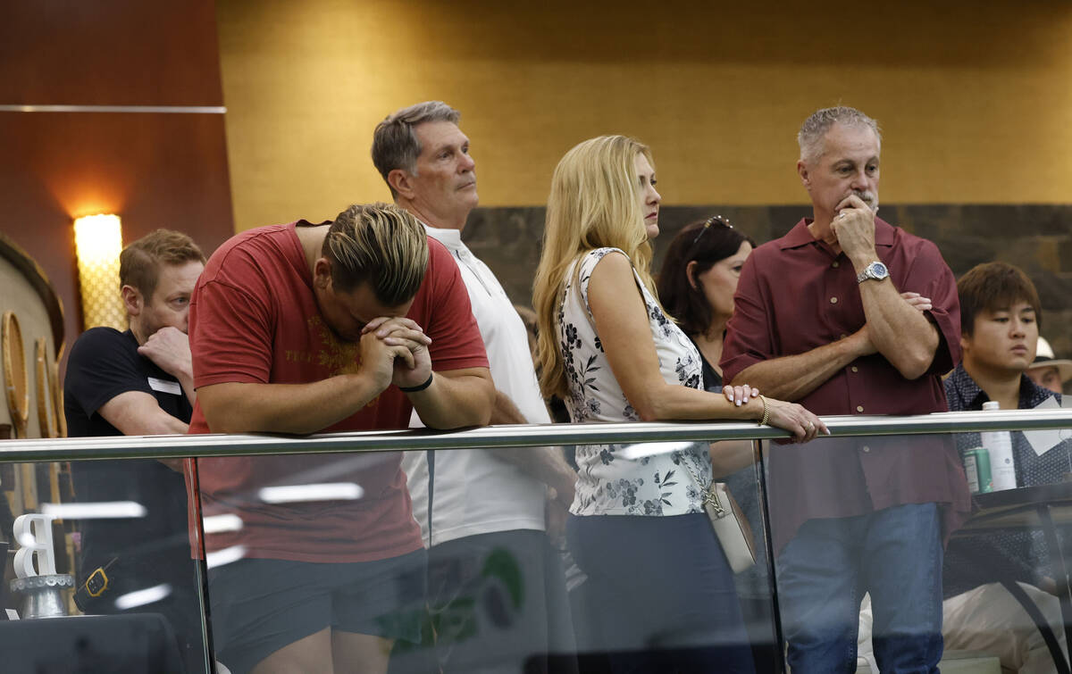 People watch a slide show to honor the memory of Brandon Farber during a candlelight vigil at t ...