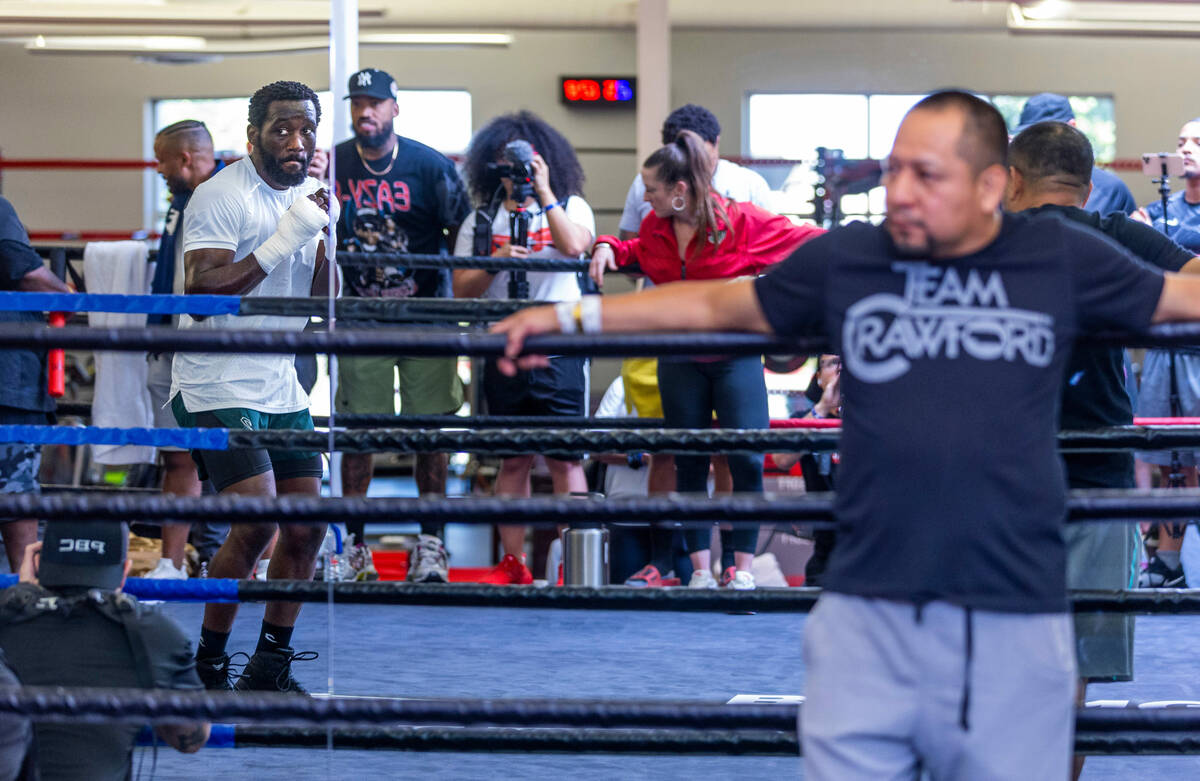 Terence Crawford shadow boxes in the ring as trainer Esau Dieguez observes him at the UFC Apex ...