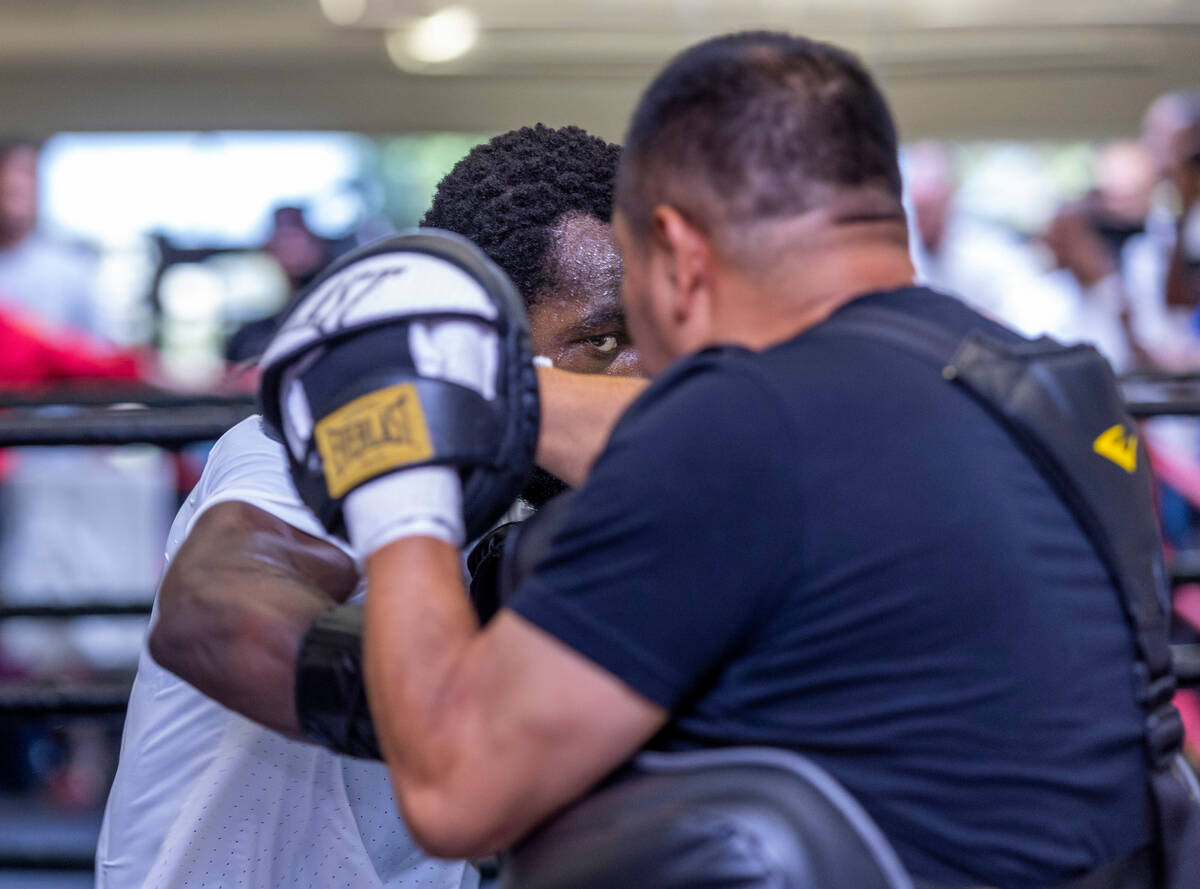 Terence Crawford hits the pads held by trainer Esau Dieguez at the UFC Apex gym on Wednesday, J ...
