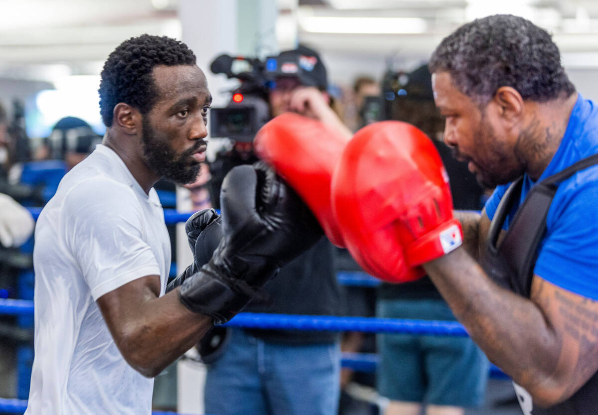 Terence Crawford strikes the pads held by trainer Red Spike at the UFC Apex gym on Wednesday, J ...