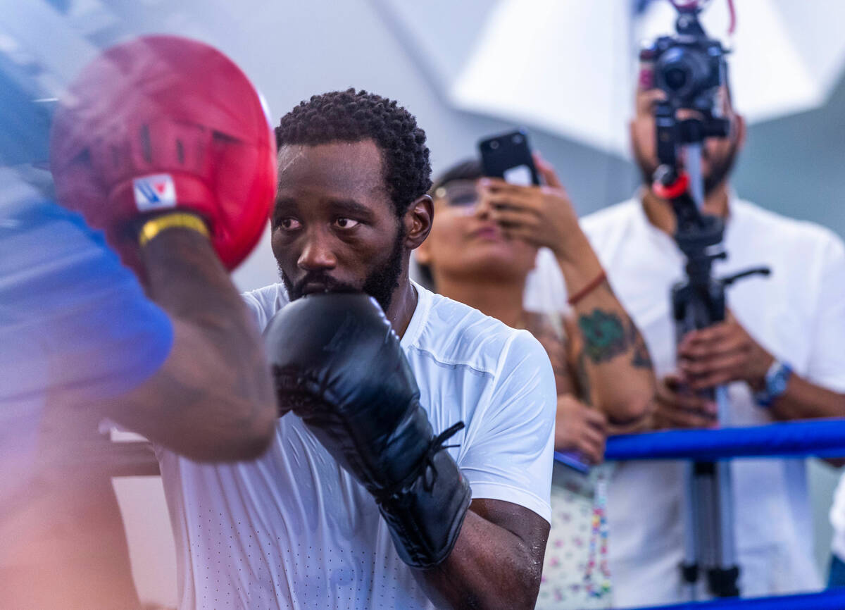 Terence Crawford strikes the pads held by trainer Red Spike at the UFC Apex gym on Wednesday, J ...
