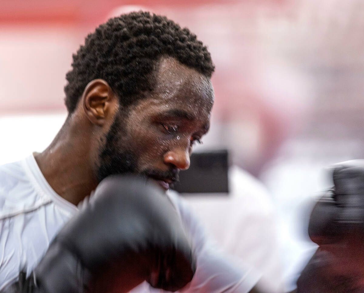 Terence Crawford sweats intensely as he strikes a heavy bag at the UFC Apex gym on Wednesday, J ...