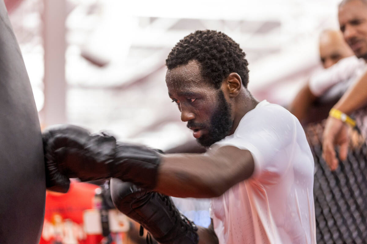 Terence Crawford sweats intensely as he strikes a heavy bag at the UFC Apex gym on Wednesday, J ...