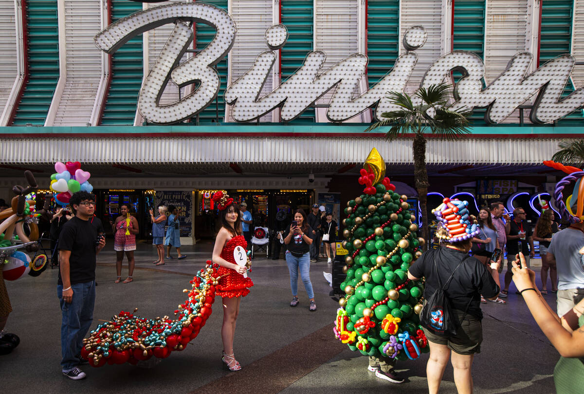 Attendees of the Bling Bling Jam balloon convention participate in a parade along the Fremont S ...