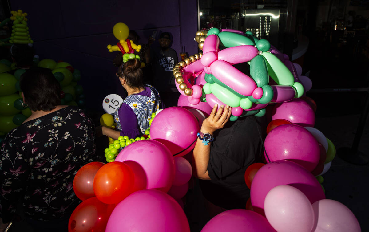Lupe Lecue of San Francisco walks in a parade led by the Bling Bling Jam balloon convention alo ...