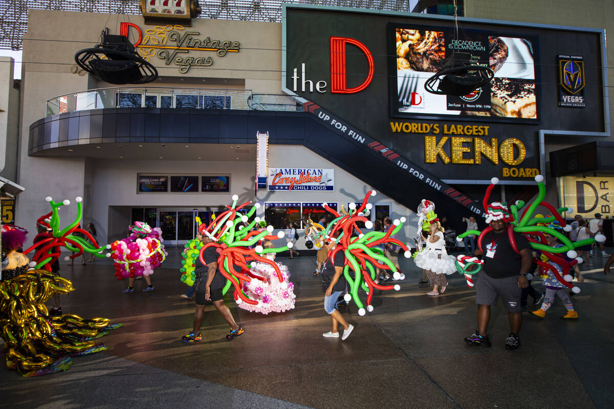 Attendees of the Bling Bling Jam balloon convention participate in a parade along the Fremont S ...