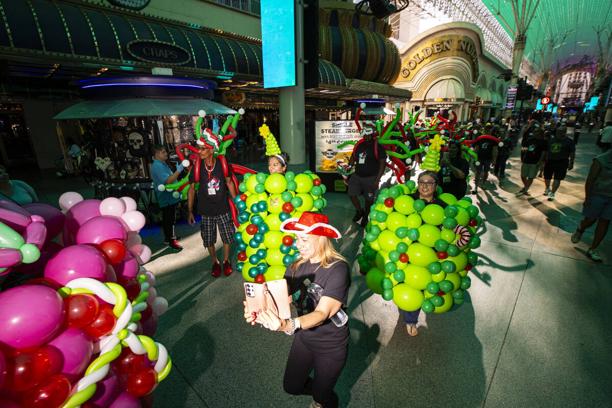 Attendees of the Bling Bling Jam balloon convention participate in a parade along the Fremont S ...
