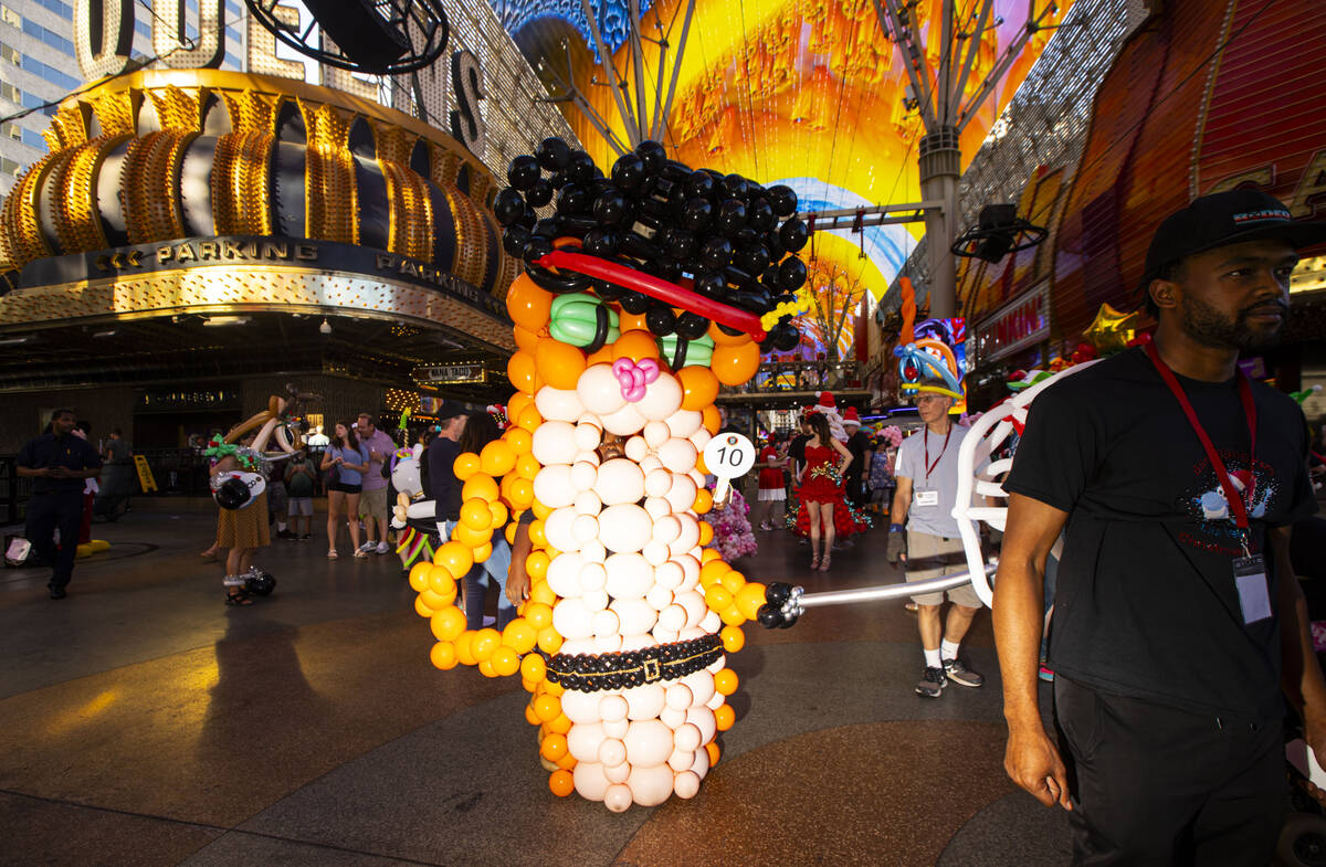 Balloon artist Alia Hymon, of Pennsylvania, dressed as Puss ’n Boots, walks in a parade ...