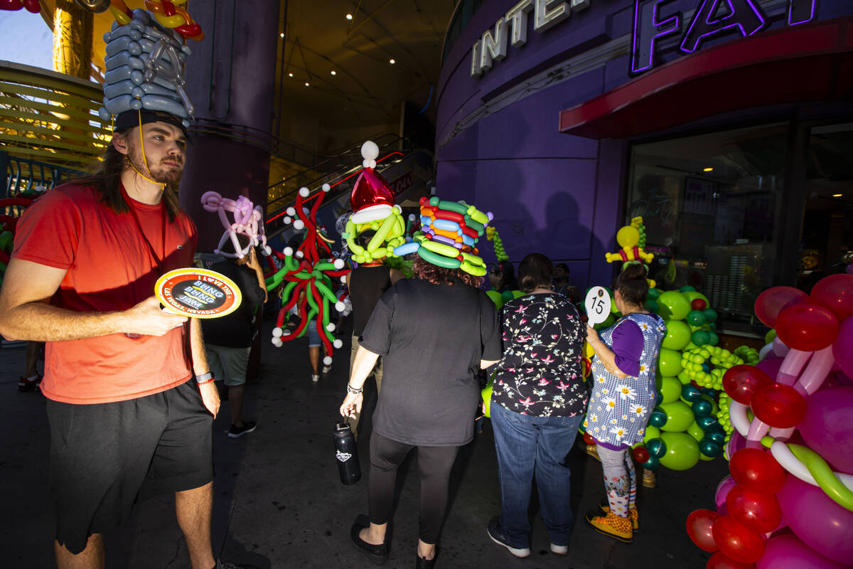 Attendees of the Bling Bling Jam balloon convention participate in a parade along the Fremont S ...