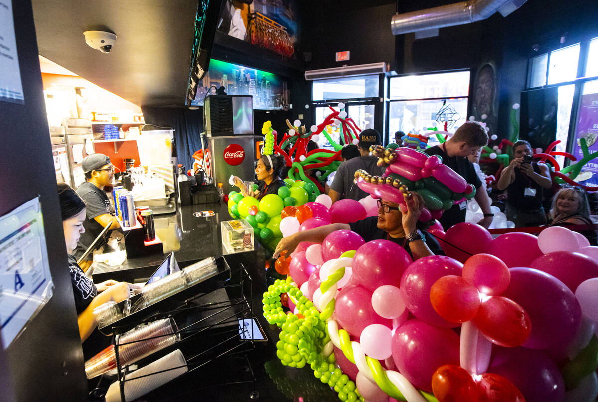 Attendees of the Bling Bling Jam balloon convention stop for refreshments after their parade al ...