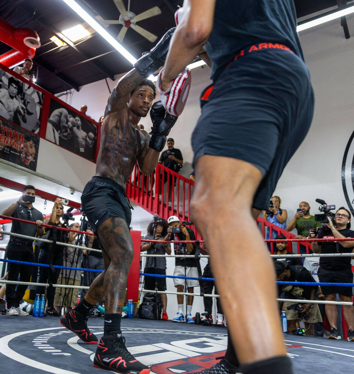 Fighter Errol Spence Jr. hits the pads with trainer Derrick James during a media workout day at ...