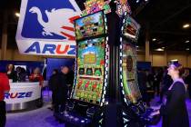 Cailey Henderson plays the Rock Paper Scissors slot game in the Aruze Gaming America booth at t ...