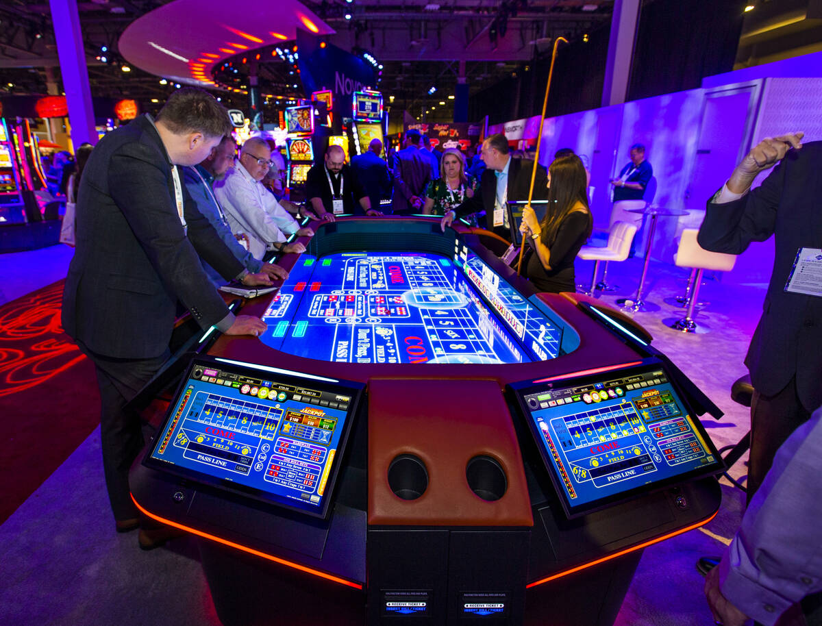 Attendees play on a new digital craps table from Aruze Gaming during the 2019 Global Gaming Exp ...
