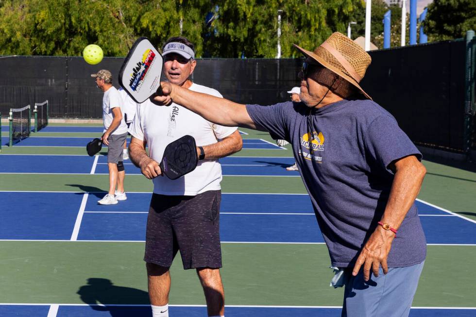 People, including Mike Trujillo, right, play pickleball at Durango Hills Park on June 30, 2023 ...
