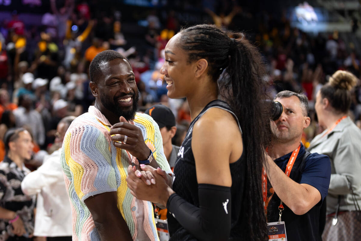 Former NBA player Dwayne Wade, left, chats with Las Vegas Aces’ forward A’ja Wils ...