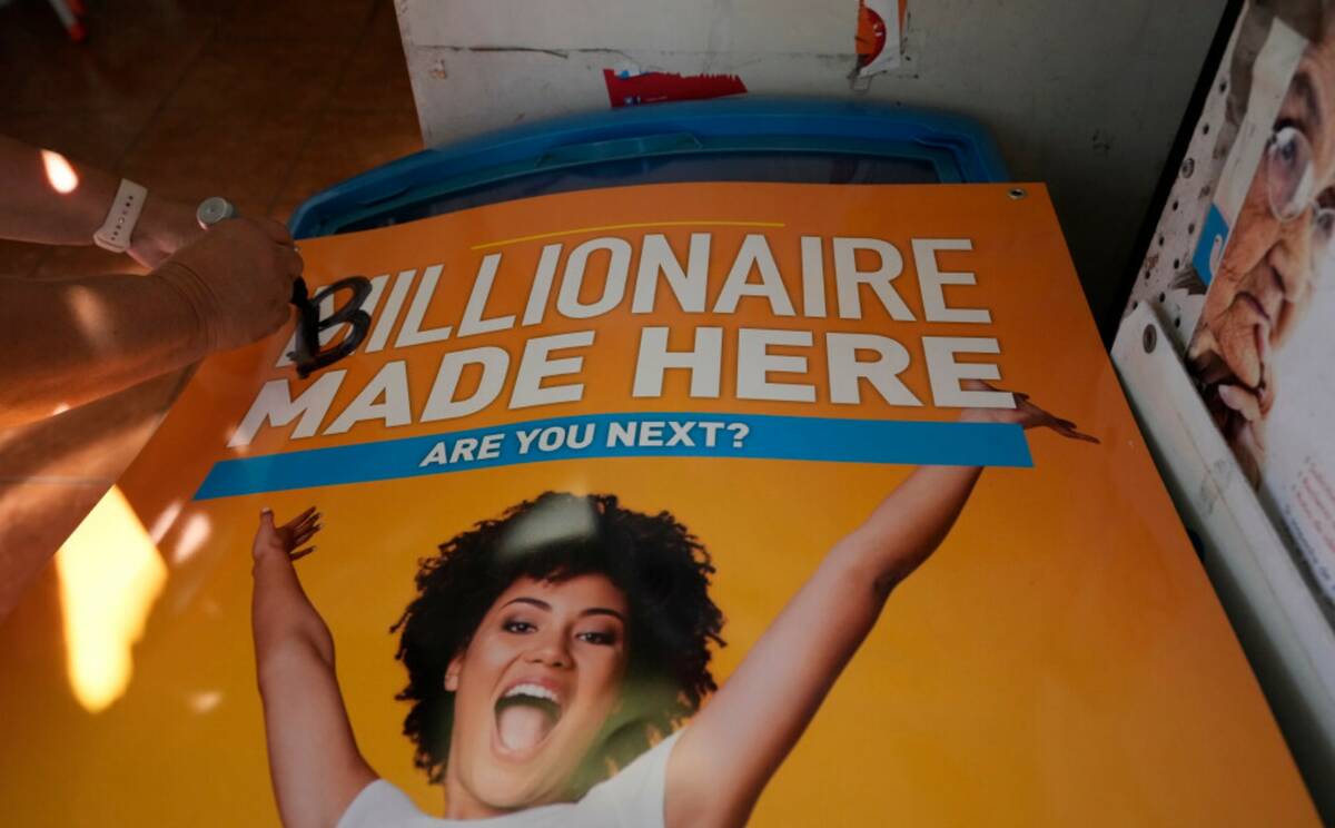 A sign is updated inside the Las Palmitas Mini Market where the winning Powerball lottery ticke ...