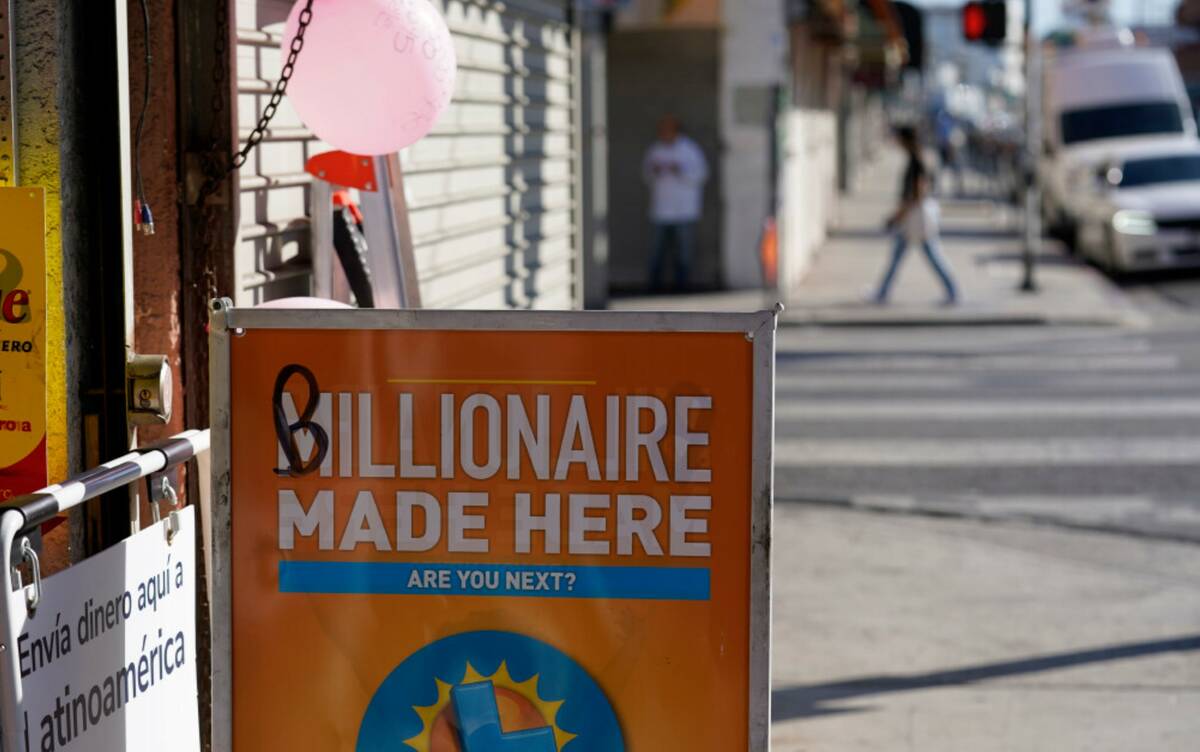 A sign is posted outside at the Las Palmitas Mini Market where the winning Powerball lottery ti ...