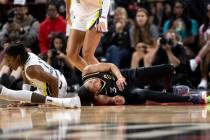 Las Vegas Aces forward Candace Parker (3) grimaces after falling to the court while Dallas Wing ...