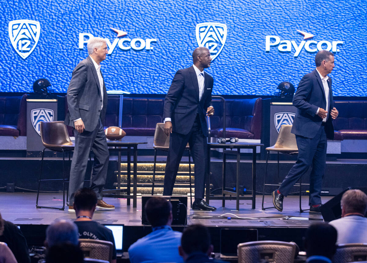 Pac-12 commissioner George Kliavkoff, left, Executive Associate Commissioner, Merton Hanks, and ...