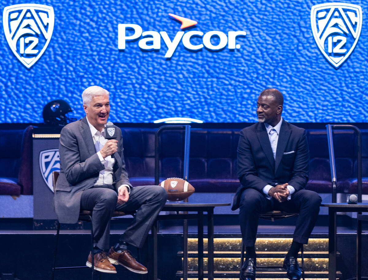 Pac-12 Commissioner George Kliavkoff, left, speaks as Executive Associate Commissioner, Merton ...