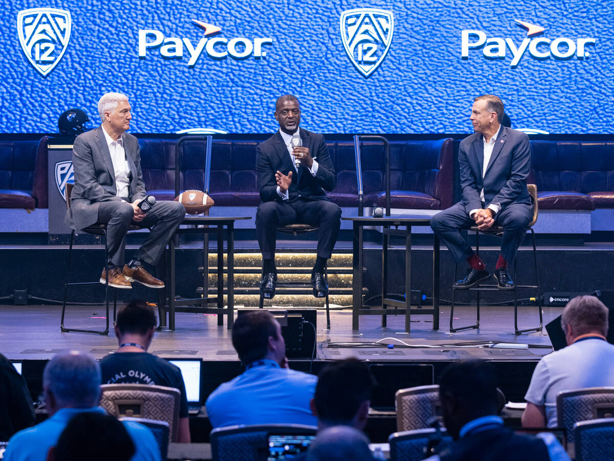 Pac-12 Executive Associate Commissioner, Merton Hanks, left, speaks as Commissioner George Klia ...