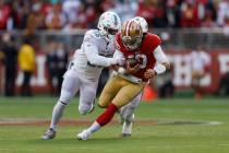 San Francisco 49ers quarterback Jimmy Garoppolo (10) scrambles before being sacked by Miami Dol ...