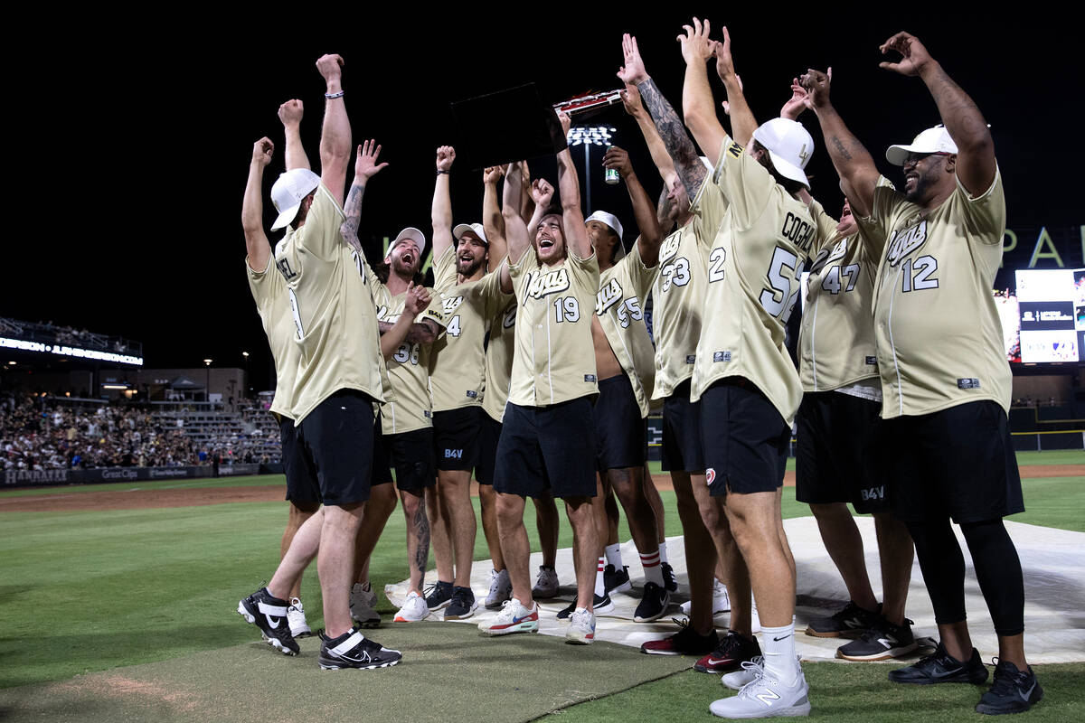 The Golden Knights celebrate after winning the annual Battle for Vegas charity softball game ag ...