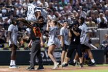 Raiders cornerback Nate Hobbs flips after scoring a home run during the annual Battle for Vegas ...