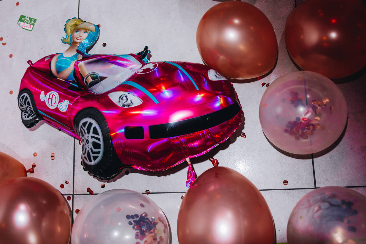 A balloon shaped like Barbie in her pink convertible is seen on the ground at a premiere party ...