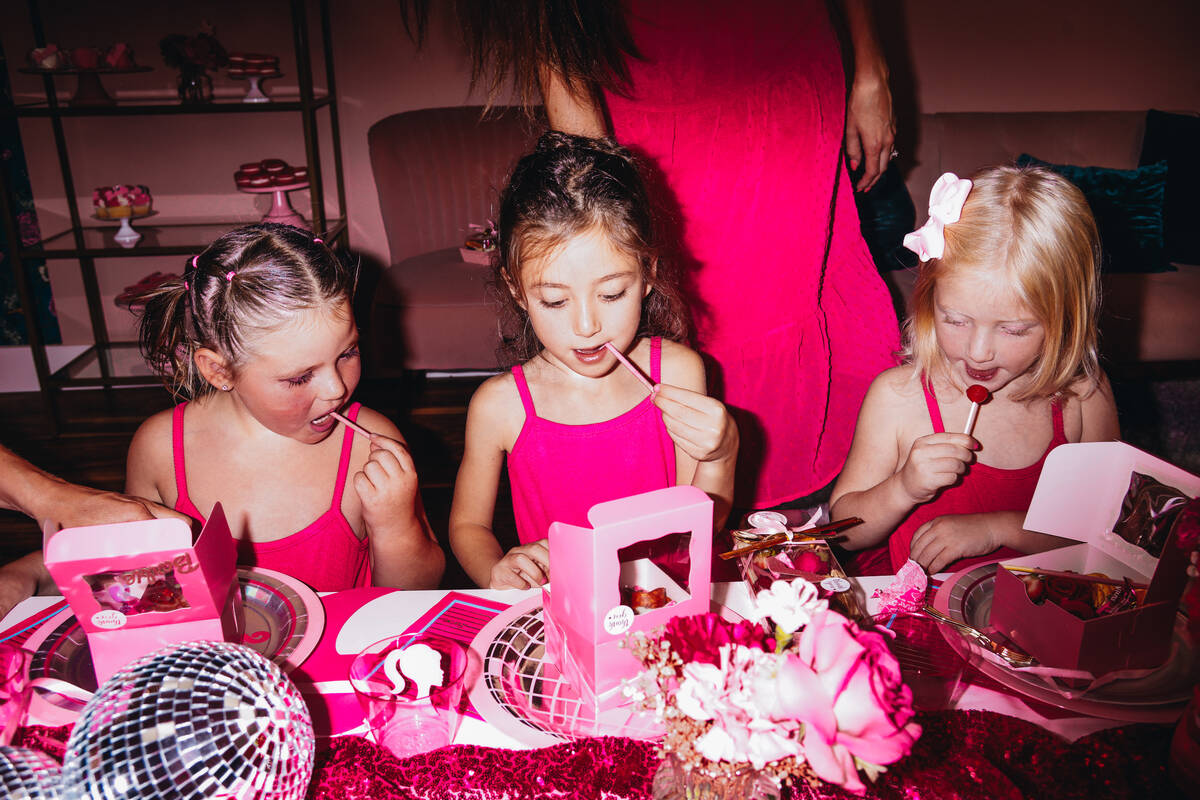 Lennon Tuck, 4, left, Penelope Cope, 4, middle, and Presley Cope, 3, sit at a Barbie themed tab ...