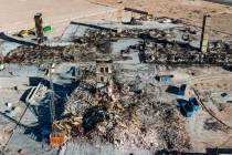 An aerial view shows large piles of debris at the scene where a fire destroyed an apartment com ...