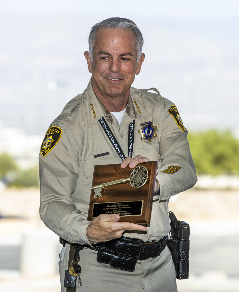 ?Sheriff Joseph Lombardo shows off the plaque he just received during a ribbon-cutting and unve ...