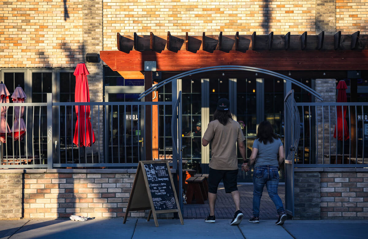 A couple enters HUDL Brewing Company in the Arts District in Las Vegas, Tuesday, July 25, 2023. ...