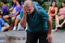 Russ Wilson splashes water on his face from a fountain in New York, Wednesday, July 17, 2019. T ...