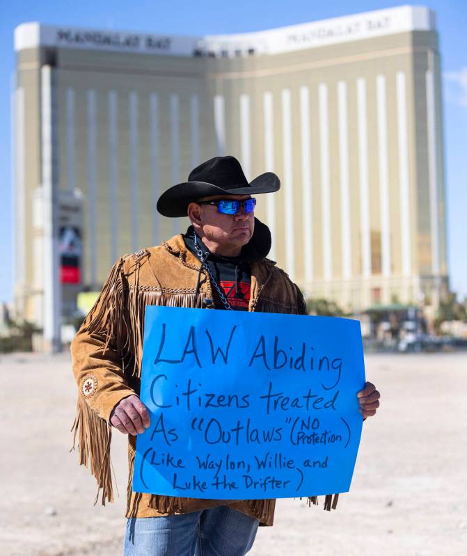 Todd Hall, a member of North Dakota's Mandan, Hidatsa and Arikara Nation (MHA), holds a sign as ...