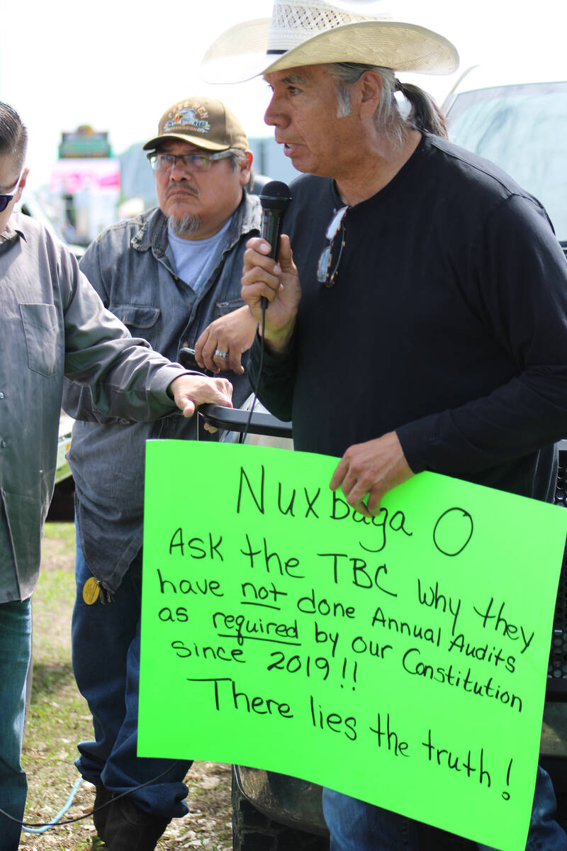 Former MHA Nation chairman Tex Hall, right, holds a sign at a protest.