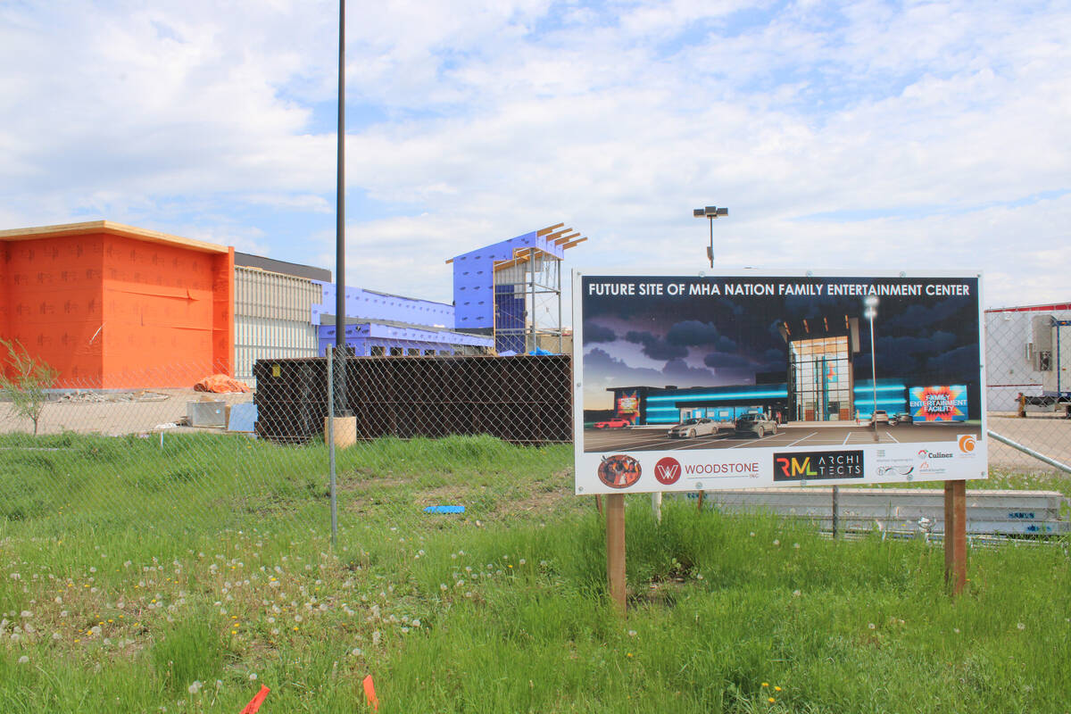 A sign shows a rendering of an under-construction entertainment center in New Town, North Dakota.