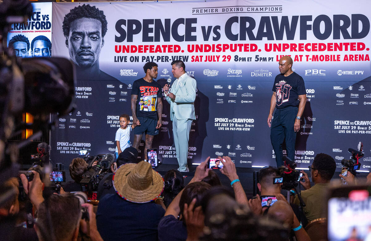 Welterweight boxer Errol Spence Jr., with his son Dallas speaks to fight commentator Ray Flores ...