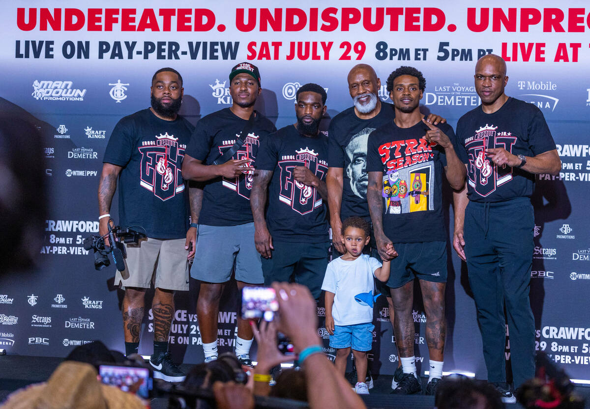 Welterweight boxer Errol Spence Jr., with his son Dallas joins members of his team during grand ...