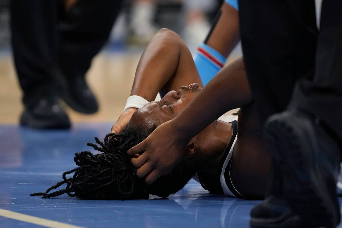 Las Vegas Aces guard Chelsea Gray lies on the court after being fouled by Chicago Sky guard Kah ...