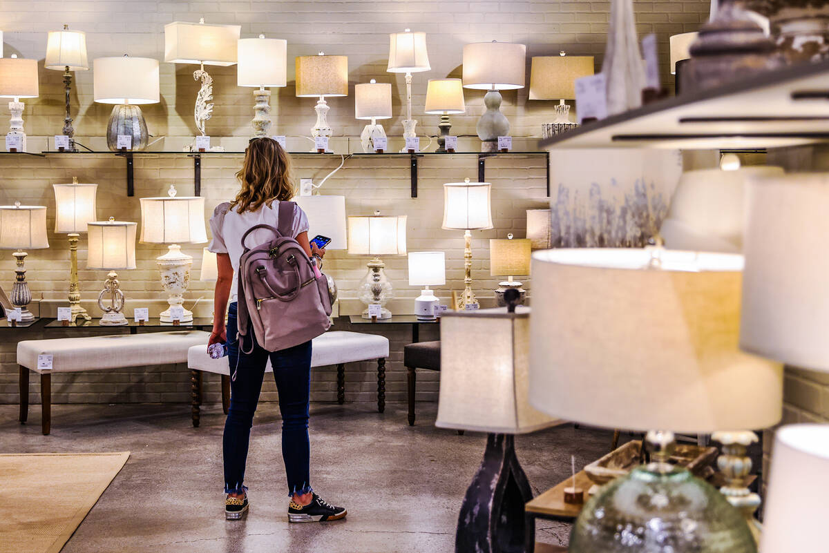 Whitney Vredenburgh, of Indiana, looks at light fixtures at the Forty West showroom at Summer M ...