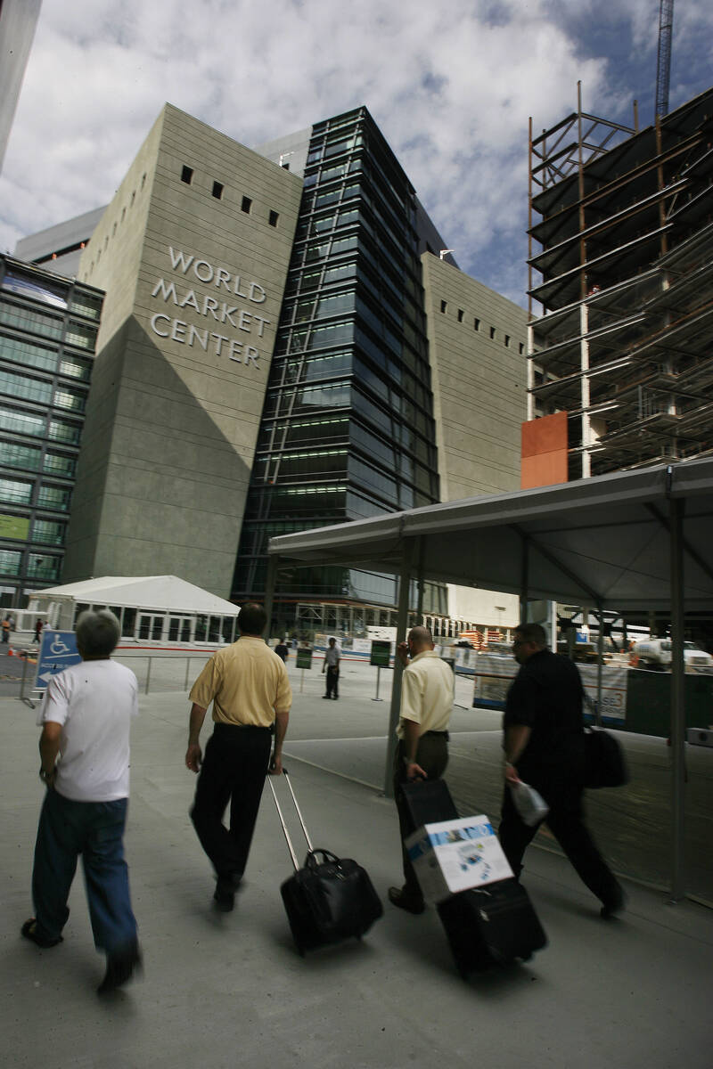 Conventioneers head towards the World Market Center to attend the Summer Market Friday, July 27 ...