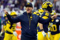 FILE - Michigan head coach Jim Harbaugh gestures during the first half of the Fiesta Bowl NCAA ...