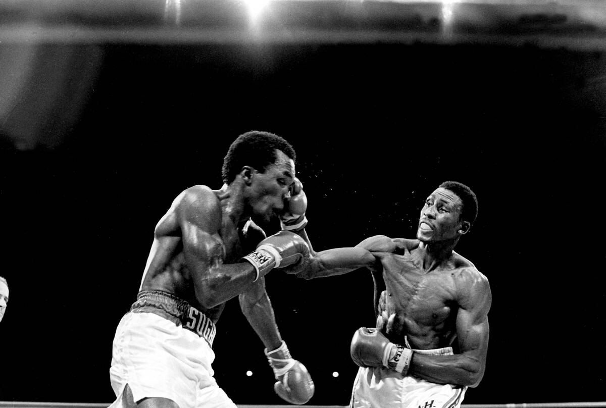Thomas Hearns hits Sugar Ray Leonard with a right to the head in their title bout in Las Vegas, ...