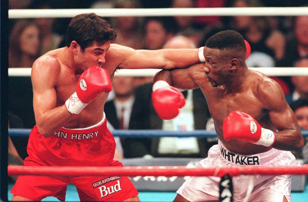 Oscar De La Hoya, left, and Pernell Whitaker fight in the third round on April 12, 1997, in Las ...