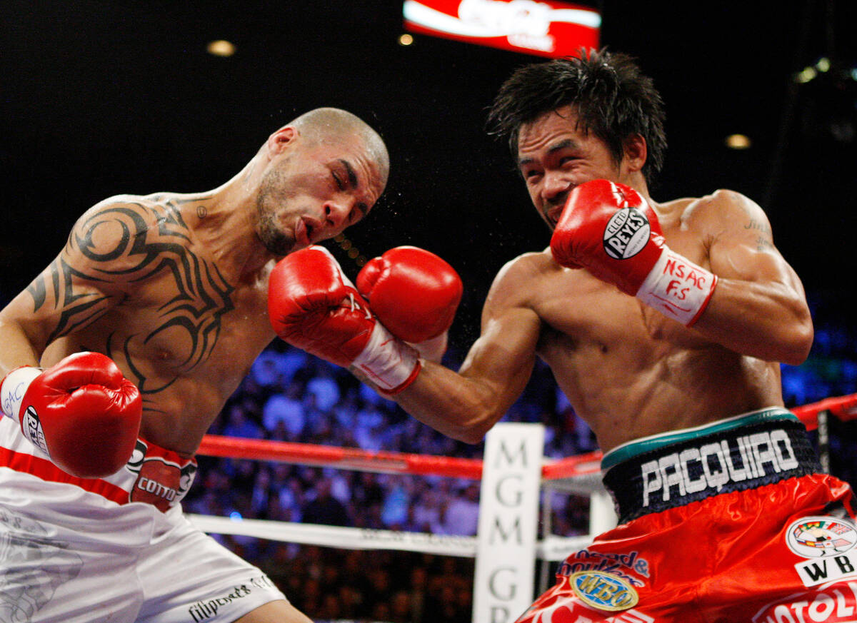 Boxer Manny Pacquiao hits his opponent Miguel Cotto during their WBO Welterweight title fight a ...