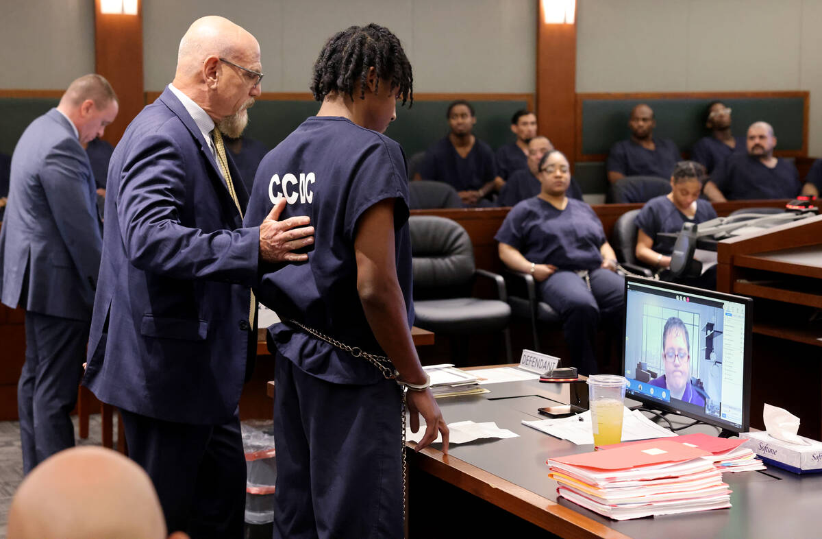 UNLV basketball recruit Zaon Collins reads a statement while being comforted by his attorney Fr ...