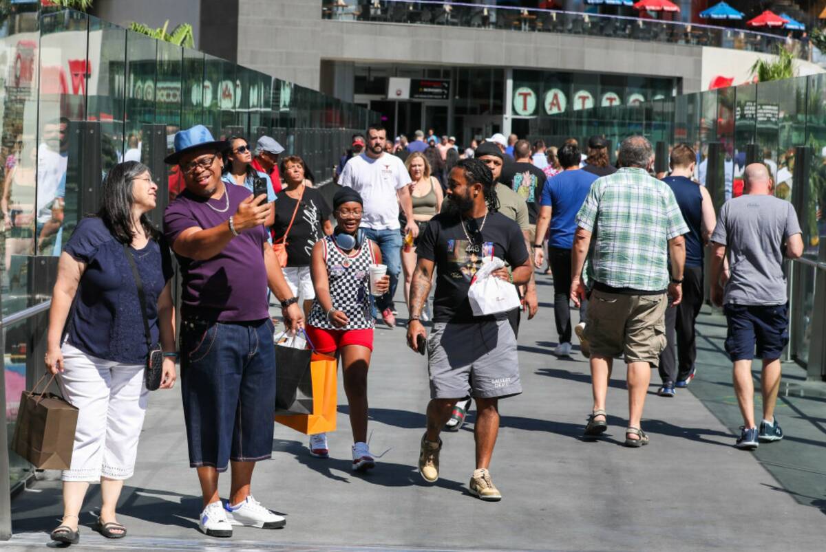 Crowds of tourists brave the heat as they walk along the Strip on Thursday, June 29, 2023, in L ...