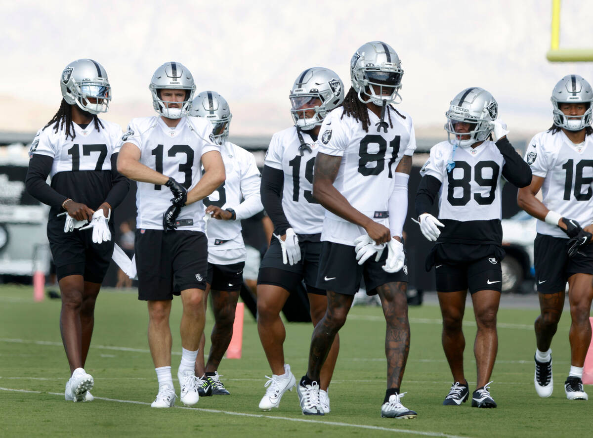 Raiders wide receivers, including Hunter Renfrow (13) and Davante Adams (17) take the field dur ...