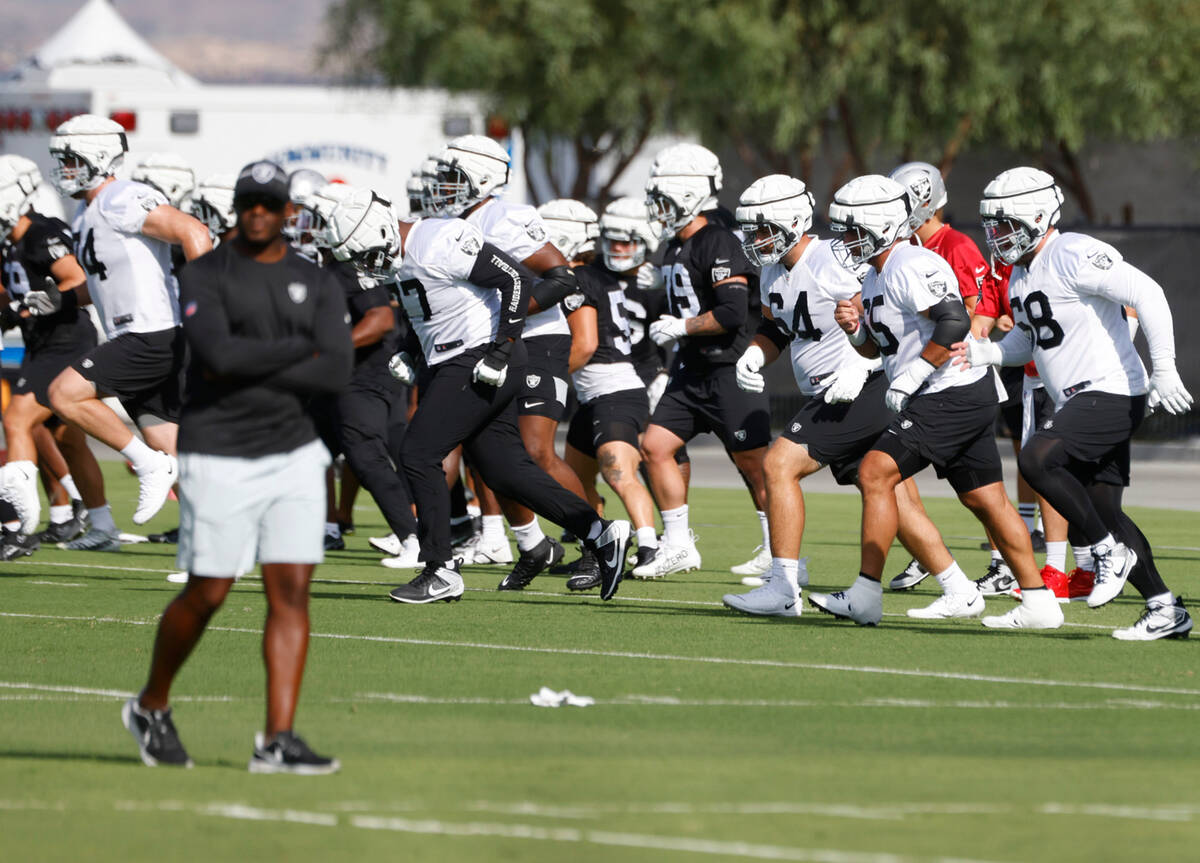 Raiders players warm up during training camp at the Intermountain Health Performance Center, on ...